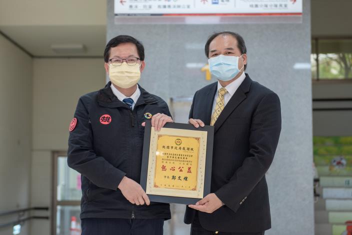 鄭市長回贈感謝狀，由桃園市消防器材工程商業同業公會理事長李春輝代表接受