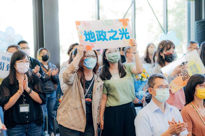 地政局同仁高舉「地政之光」手牌，支持獲獎的地政局科長吳澍源