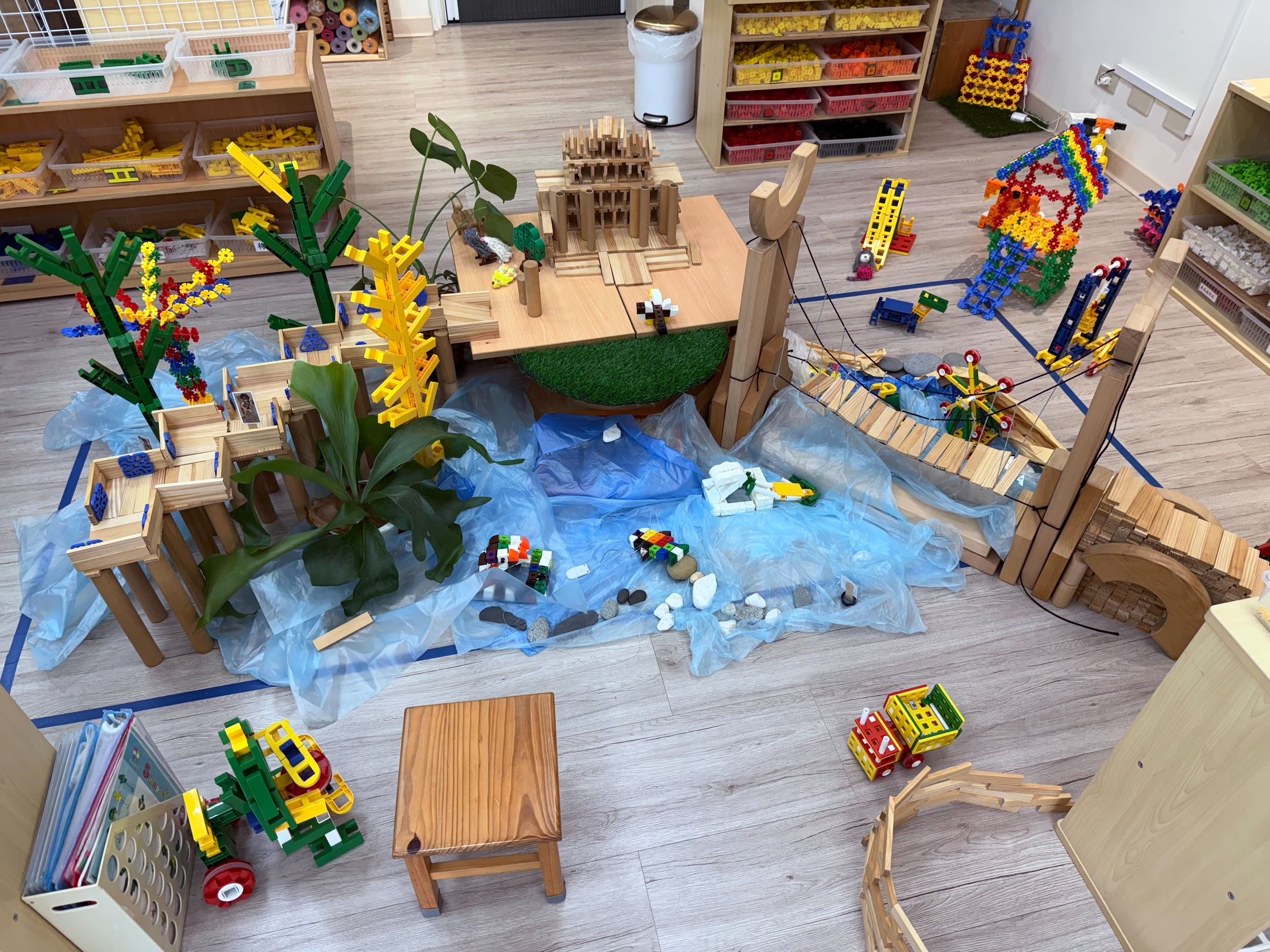 龍潭幼兒園幼生和老師在積木區合作堆疊象徵在地特色的「龍潭大池吊橋」,在遊戲中自然學習客語